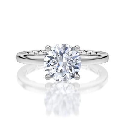 A timeless solitaire engagement ring showcasing an round-cut center diamond. Its clean, elegant lines make it an enduring choice for those who appreciate refined simplicity. MECRD2959Q/308